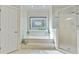 Bright bathroom featuring a soaking tub under a stained-glass window and a separate glass-enclosed shower at 3803 Mill Creek Ct, Atlanta, GA 30341