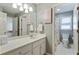 Bright bathroom featuring a large mirror, double vanity, and a separate toilet room with shower/tub combination at 3803 Mill Creek Ct, Atlanta, GA 30341