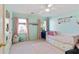 Charming bedroom with turquoise walls, pink curtains, carpeted floor, and built-in storage at 3803 Mill Creek Ct, Atlanta, GA 30341
