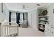Bedroom featuring a crib, chair, and nautical-themed decor, complete with shelves for storage and decorations at 3803 Mill Creek Ct, Atlanta, GA 30341