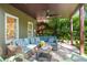 Covered patio has comfortable seating, a ceiling fan, and a view of the lush backyard at 3803 Mill Creek Ct, Atlanta, GA 30341