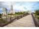 Scenic view of community bridge over a pond with city buildings in the background at 400 17Th Nw St # 1315, Atlanta, GA 30363