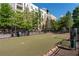 Enclosed dog park with artificial turf and waste station, ideal for pet owners in the community at 400 17Th Nw St # 1315, Atlanta, GA 30363