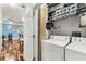 Well-equipped laundry room with washer, dryer, and shelving for organized storage, conveniently located near the living area at 400 17Th Nw St # 1315, Atlanta, GA 30363