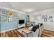 Inviting living room featuring hardwood floors, blue accent wall with art, and a comfortable couch at 400 17Th Nw St # 1315, Atlanta, GA 30363