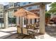 Charming outdoor patio area with shaded seating, perfect for dining and relaxation by the fenced pool at 400 17Th Nw St # 1315, Atlanta, GA 30363