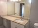Bright bathroom featuring granite counters and an expansive vanity with a large mirror at 4018 Woodridge Way, Tucker, GA 30084