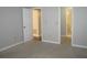 Empty bedroom has neutral carpet and paint, and two entryways leading to a closet and a bathroom at 4018 Woodridge Way, Tucker, GA 30084
