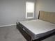 Bedroom with a modern platform bed frame, tufted headboard, and a bright window at 4018 Woodridge Way, Tucker, GA 30084
