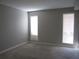 Cozy bedroom has plush carpeting and two large windows for natural light to flow through the space at 4018 Woodridge Way, Tucker, GA 30084