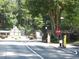 Gated community entrance showing a stop sign and security features in a lush, wooded setting at 4018 Woodridge Way, Tucker, GA 30084