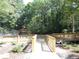 A wooden walkway and gazebo add to the recreational amenities within a wooded, peaceful community at 4018 Woodridge Way, Tucker, GA 30084