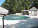 A community pool is covered in the off-season, with a pool house and trees in the background at 4018 Woodridge Way, Tucker, GA 30084