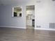 Living room view to the kitchen featuring a pass-through window and white cabinets at 4018 Woodridge Way, Tucker, GA 30084