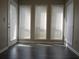 Sun room with gray plank flooring, a door, and a wall of windows with blinds at 4018 Woodridge Way, Tucker, GA 30084