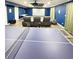 Entertainment room with projector screen, seating, ping pong table, and neutral flooring at 4685 Trefoil Path, Cumming, GA 30040