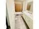 Bathroom with gray tile flooring, double vanity, and a toilet in a separate area at 4685 Trefoil Path, Cumming, GA 30040