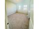 Bright, carpeted bedroom with neutral walls, two windows, and natural light at 4685 Trefoil Path, Cumming, GA 30040