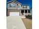 Charming two-story home with a brick facade, a covered porch, and a two-car garage at 4685 Trefoil Path, Cumming, GA 30040