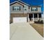 Charming two-story home featuring a brick and gray facade, complemented by a well-maintained front lawn at 4685 Trefoil Path, Cumming, GA 30040