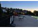 Community pool with splashpad, seating, and fence at dusk at 4685 Trefoil Path, Cumming, GA 30040