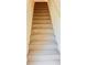 Carpeted stairway showcasing neutral tones with white trim, seamlessly connecting different levels of the home at 4685 Trefoil Path, Cumming, GA 30040
