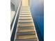Staircase featuring fresh paint and modern design, providing a seamless transition between floors at 4685 Trefoil Path, Cumming, GA 30040