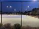 Night view of tennis courts with lights and fence at 4685 Trefoil Path, Cumming, GA 30040