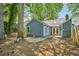 View of backyard with mature trees and a concrete patio at 5126 Farm Place Ne Dr, Woodstock, GA 30188