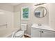 Bright, updated bathroom with white fixtures and a modern vanity at 5126 Farm Place Ne Dr, Woodstock, GA 30188