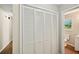 Hallway storage with a full bathroom that includes new floors and updated vanity at 5126 Farm Place Ne Dr, Woodstock, GA 30188