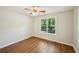 Cozy bedroom with new floors, a large window, and neutral paint at 5126 Farm Place Ne Dr, Woodstock, GA 30188