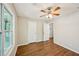 Bedroom boasts a ceiling fan, spacious closet, neutral paint, and new flooring at 5126 Farm Place Ne Dr, Woodstock, GA 30188
