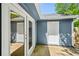 Exterior view showcasing a door and windows, surrounded by an outdoor patio area at 5126 Farm Place Ne Dr, Woodstock, GA 30188