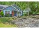 Charming blue home features a bright red front door, large window, and well-maintained lawn at 5126 Farm Place Ne Dr, Woodstock, GA 30188