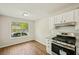 Eat-in kitchen offers bright natural light, stainless steel appliances, and granite countertops at 5126 Farm Place Ne Dr, Woodstock, GA 30188