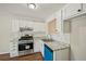 Well-lit kitchen with white cabinets, granite countertops, stainless steel appliances, and subway tile at 5126 Farm Place Ne Dr, Woodstock, GA 30188