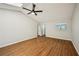 Expansive living room featuring wood floors, a ceiling fan, and great natural light at 5126 Farm Place Ne Dr, Woodstock, GA 30188