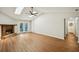 Inviting living room with skylights, fireplace, wood floors, and French doors to the backyard at 5126 Farm Place Ne Dr, Woodstock, GA 30188