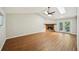 Bright living room with a fireplace, French doors, wood floors, and a ceiling fan at 5126 Farm Place Ne Dr, Woodstock, GA 30188