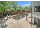 Backyard featuring a swimming pool, spa, outdoor lounge area, and lush landscaping at 1751 Bergen Ct, Lawrenceville, GA 30043