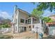 Backyard featuring a swimming pool, mature trees, and outdoor lounge area at 1751 Bergen Ct, Lawrenceville, GA 30043