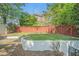 Fenced backyard featuring a well-maintained lawn and mature trees at 1751 Bergen Ct, Lawrenceville, GA 30043