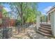 Landscaped backyard featuring a charming wrought iron gate and stone pathway at 1751 Bergen Ct, Lawrenceville, GA 30043