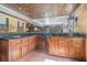Bar area featuring custom wood cabinetry, a black countertop, and ample storage space at 1751 Bergen Ct, Lawrenceville, GA 30043