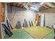Unfinished basement with green floor, exposed ceiling, and building materials at 1751 Bergen Ct, Lawrenceville, GA 30043
