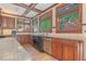 Kitchen featuring custom cabinets, granite counters, stainless steel appliances, and decorative tile backsplash at 1751 Bergen Ct, Lawrenceville, GA 30043