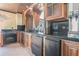 Kitchenette area featuring custom cabinetry, black countertops and decorative tin ceiling at 1751 Bergen Ct, Lawrenceville, GA 30043