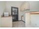 Bright laundry room with granite countertops, clean white cabinetry and tile floors at 1751 Bergen Ct, Lawrenceville, GA 30043