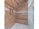 Large shower features wood-look tile and a built-in seat with multiple shower heads at 1751 Bergen Ct, Lawrenceville, GA 30043